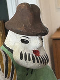 Close-up of head and hat of Kargopol clay figurine toy