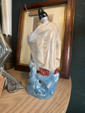 Rear view of 'May Night' figurine with cream cloak and blue base