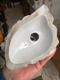 Underside of the figurine, showing an unmarked base with a central vent hole and some typical signs of wear along the foot rim.