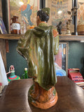 Rear of the statue showing the flowing green military coat and cap, with gloss glaze and naturalistic texture.