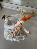 Three-quarter view of the figurine capturing the dynamic pose, elaborate feathers, and the richly painted Firebird with gilded highlights.