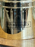 Close-up of Piper-Heidsieck logo on gold coloured champagne cooler