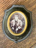 Antique shield-shaped photo case with oval portrait of a bearded man, late Victorian to Edwardian period.