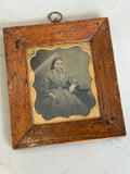 Antique oak frame with copper surround housing Victorian portrait.