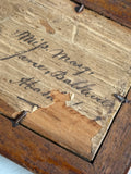 Reverse of daguerreotype frame showing handwritten inscription.
