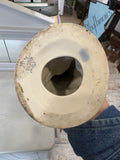 Underside of the figurine showing a worn porcelain base with the faint blue Gorodnitsa factory mark and impressed model number.