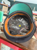 Close-up of the peaked helmet interior with green rim and size label
