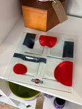 Overhead view of a vintage 1980s Martini apero tray with frosted glass and red black geometric design