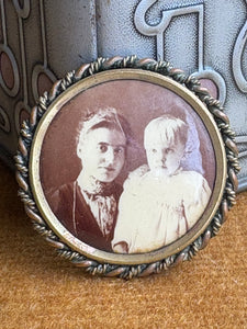 Antique Victorian tintype photo brooch with portrait of woman and child in gilded brass frame. 