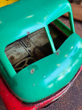 Close-up of green cab top and open windows on vintage Wells-Brimtoy 1950s tinplate toy truck
