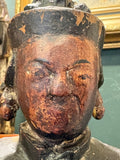 	Front close-up of painted red-brown face on antique Chinese Guanyin figure