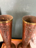 View looking down into the paired vases showing brass rims and interior form