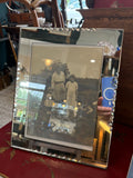 Art Deco mirrored frame holding vintage family photograph, angled view