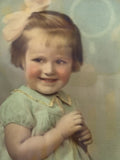 Close-up of hand-coloured child’s portrait showing painted facial detail