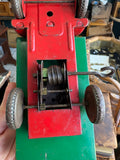 Close-up of clockwork wire spring and gear assembly on underside of Wells-Brimtoy tinplate flatbed truck