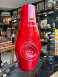 Red drip glaze vase showing spiral medallion detail, front view