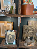 Art Deco mirrored photo frame on display, wider shop setting