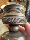 Close-up of candle cup rim showing carved trellis band