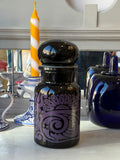 1960s Belgian black glass apothecary jar with purple psychedelic design and bubble-top lid