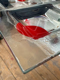 Close-up of the corner and edge detail of a vintage frosted glass Martini apero tray