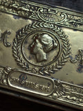 Close-up of Princess Mary portrait and monogram on brass tin lid