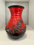 West German pottery vase with crusty black glaze texture over red gloss ceramic