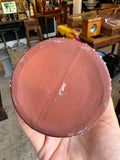 Base of drip glaze vase showing textured unglazed clay