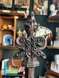 Close-up of the carved scrollwork finial crest on an antique Gothic Revival oak lectern