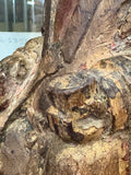Close-up of carved hand holding vessel on antique Chinese wood figure