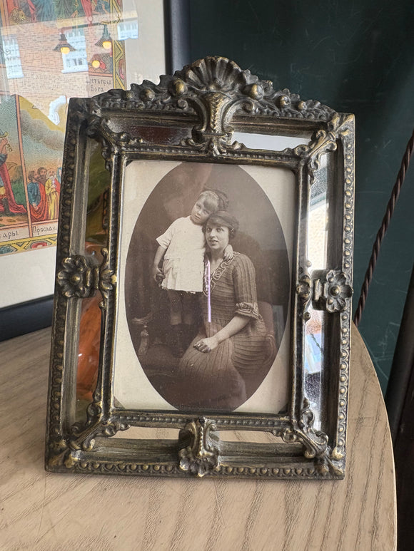 Edwardian postcard of mother and child in ornate mirrored frame. 