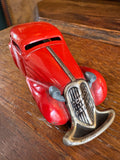 Schuco Patent Reversible Sedan, red clockwork car, front angled view