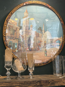 1920s framed lithograph of Arabic street scene by James Greig in decorative circular wooden frame. 