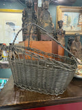 Single wine basket in profile, showing angled open side and woven body