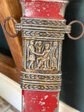 Detail of the scabbard’s upper suspension band, showing metal loop rings and a relief panel depicting Roman figures.