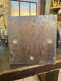 Underside of antique oak money box showing brass screws