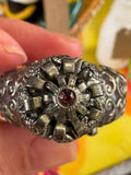 Top view of ornate crown stopper on vintage Czech amethyst filigree perfume bottle