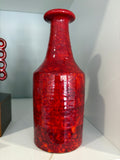 Manfred Buchholz 1970s mottled red studio pottery bottle vase, front view on shelf