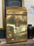 Back of lantern showing plain brass panel, clip fitting and carry handle