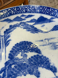 Detail of blue and white landscape decoration with mountains and water scene