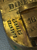 Close-up of Gurented 50 Years and 10 Levers stamp on padlock
