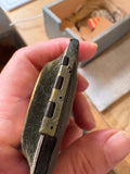 Close-up of metal hinge on antique photo case showing aged wear, late Victorian/Edwardian.