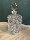 Art Deco cut-glass perfume bottle with silver collar and faceted stopper