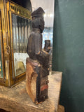 Side profile of antique Chinese carved wood ancestor figure on base