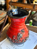 Overhead view into black glazed interior of vintage pottery vase