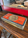 Boer War chocolate tin on antique table, full view