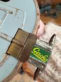 Rear axle detail of Gescha R-558 tin Porsche 356 toy car showing original maker’s label