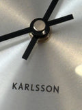Karlsson logo on brushed silver wall clock dial