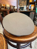 Top of the olive twill crown of a Soviet Air Force officer's peaked cap with blue piping at the edge