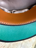 Close-up of the tan sweatband stitching and green textured underside of the peak on an RAF service dress cap