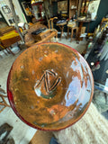Base of red drip glaze vase showing impressed monogram mark